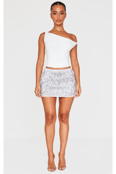 Маленька срібляста міні-спідниця з китицями